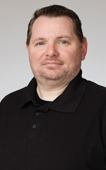 josh in black shirt with brick background