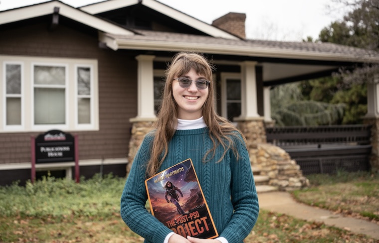 Natalie Martinaitis holds a proof of her book's cover