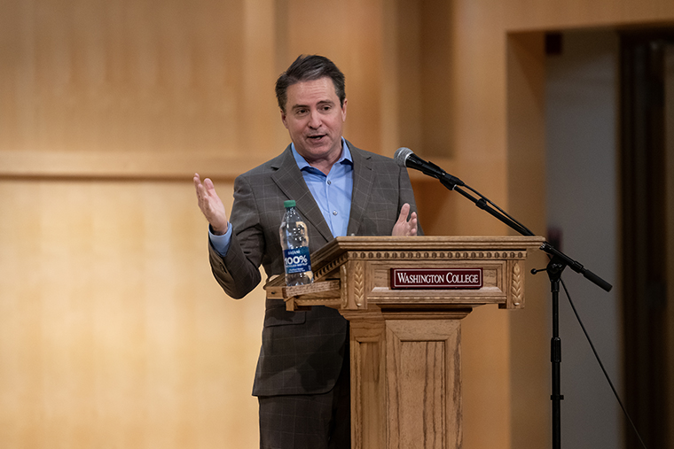 Robert P. Jones speaks behind a lectern that has a 