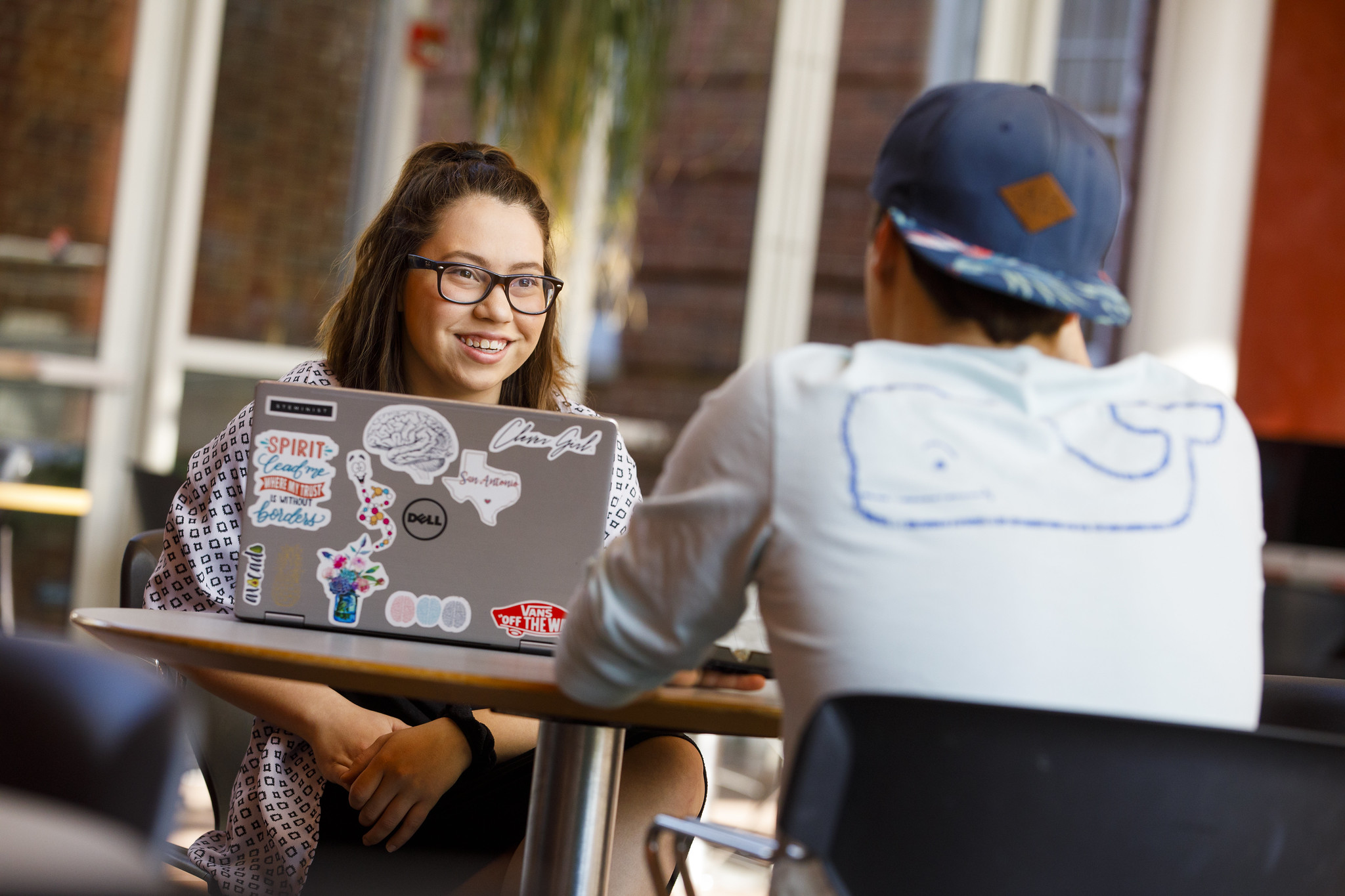 Students sitting at a table with computers