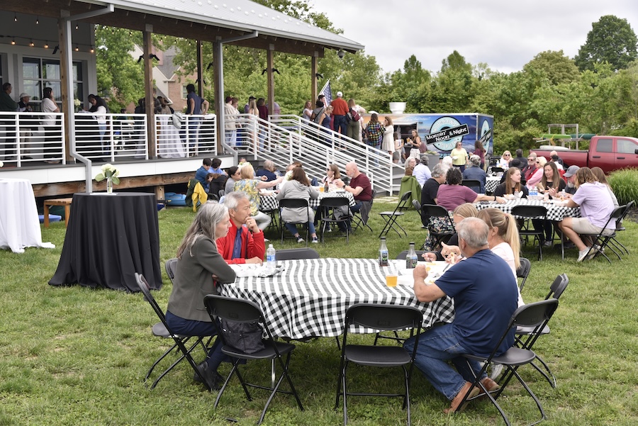 people seated at tables outside of Hodson Boathouse