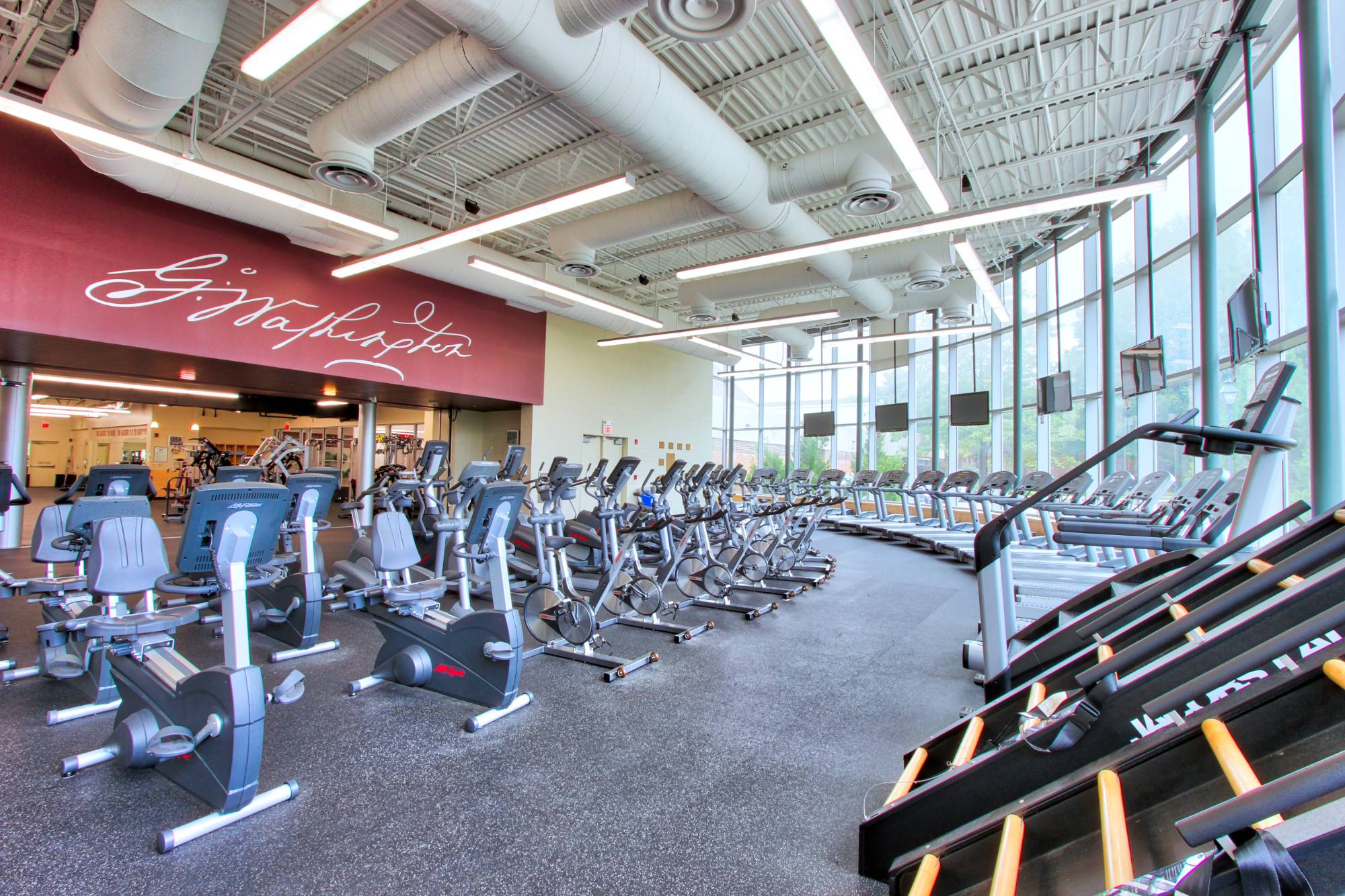 treadmills and stationary bikes in fitness cener