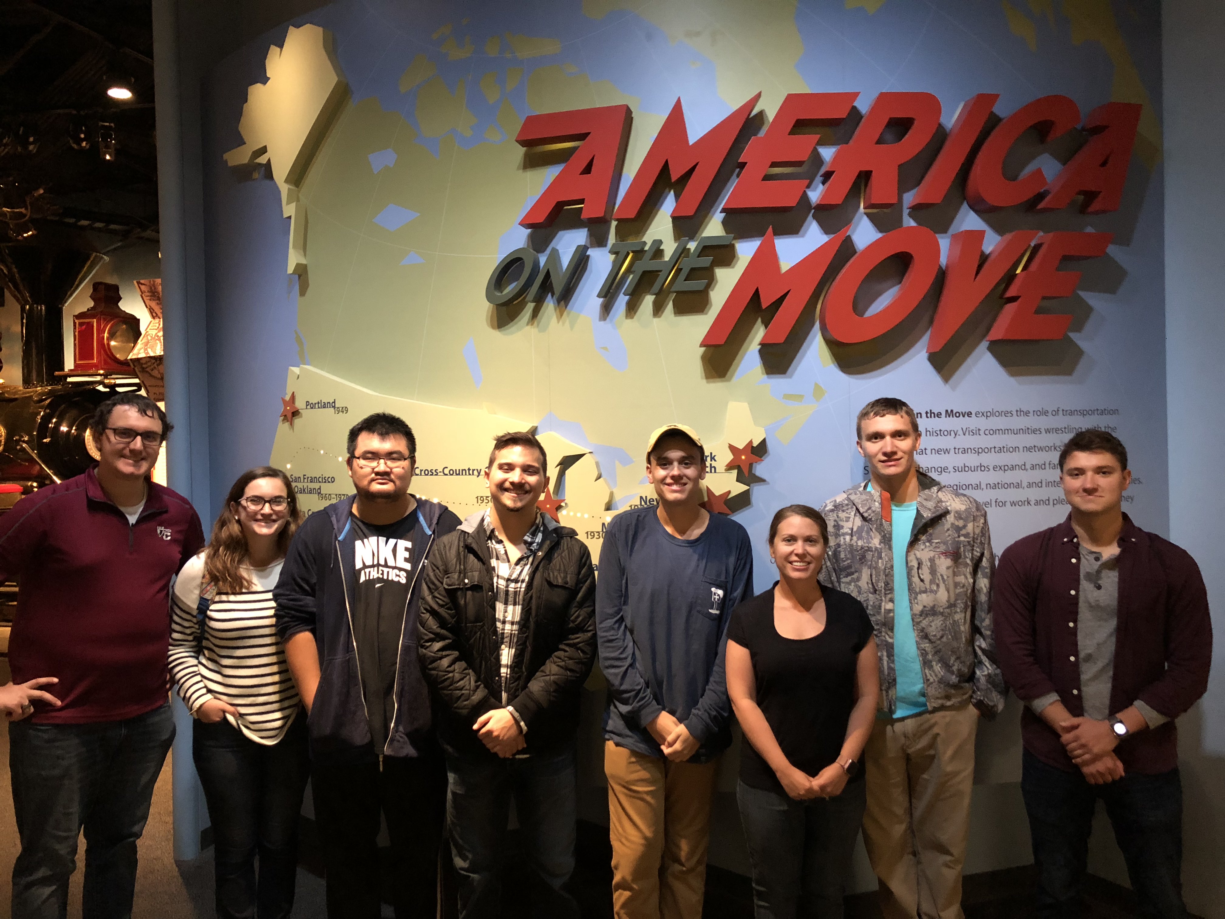 Group in front of America on the Move sign