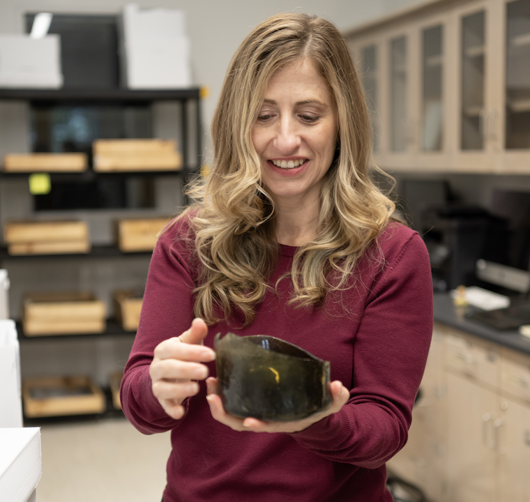 Julie Markin holds an artifact from a recent regional excavation