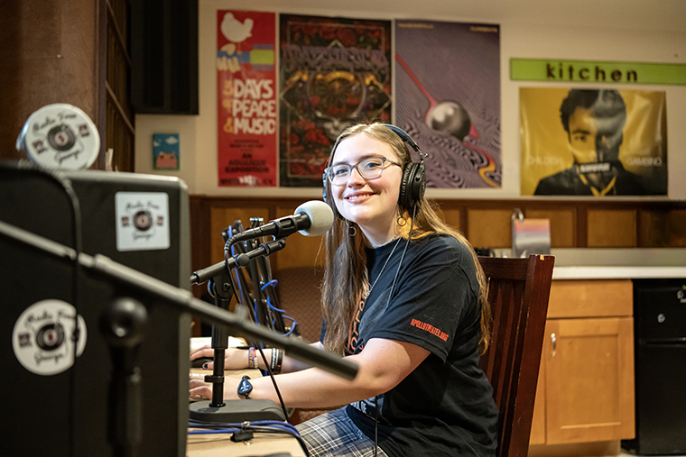 Faith Jarrell '25 sits at the recording desk at Radio Free George