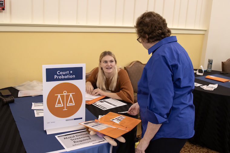 Washington College sociology major Faith Poulton conducts a poverty simulation at the Maryland Association of Social Services Boards conference.