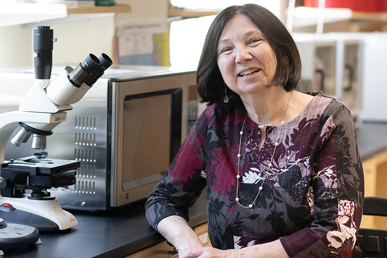 Professor Kate Verville sits in her lab