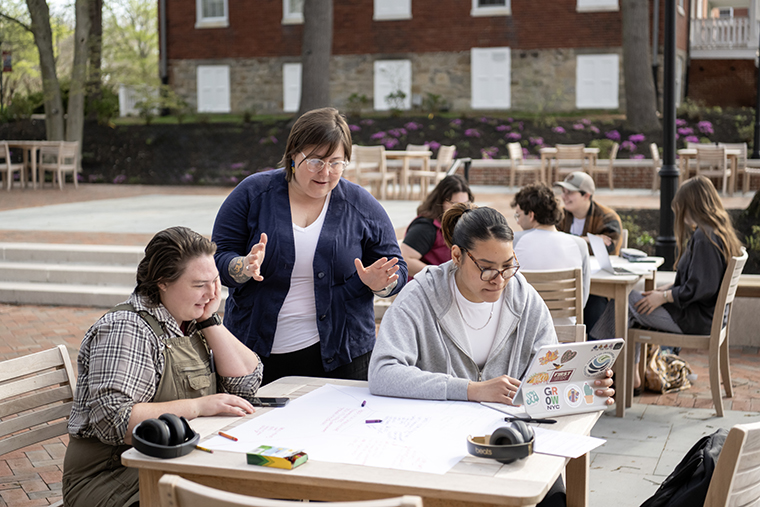 Professor Sara Clarke-De Reza speaks with students on the library terrace