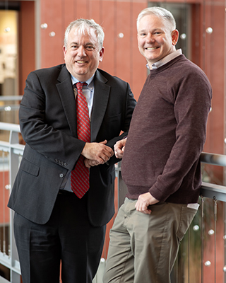 Matt Murray '95 and Professor Andrew Oros stand together in the Toll Atrium