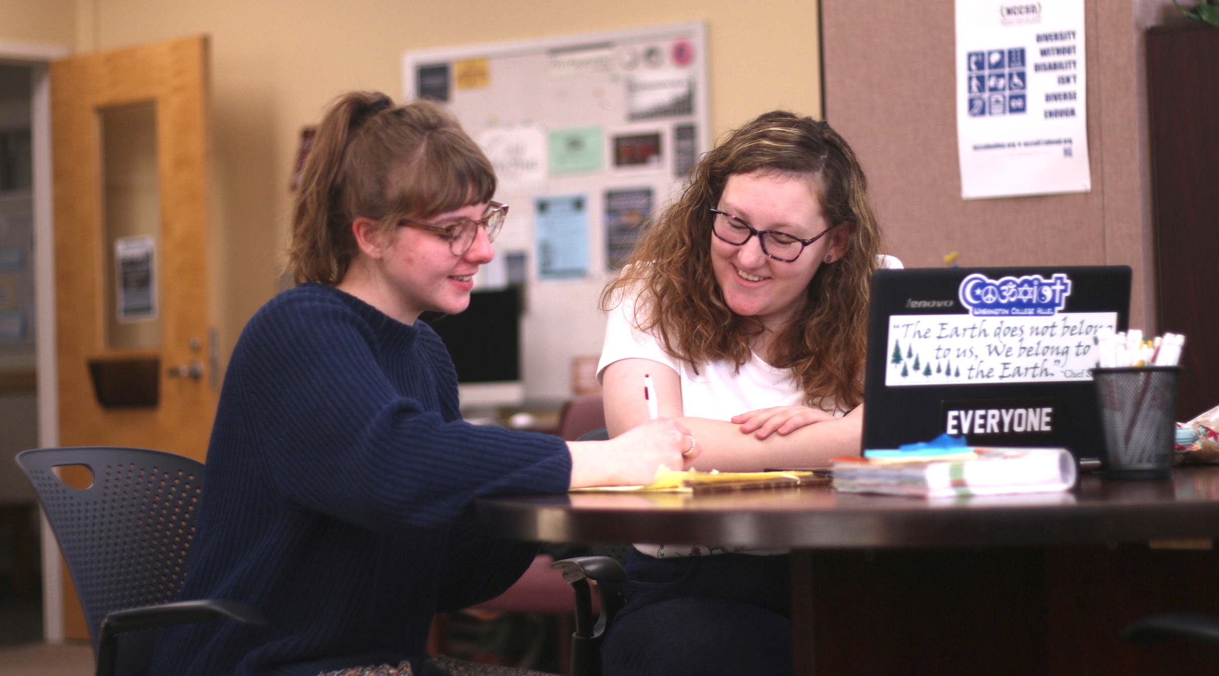 Two people sitting in the writing center