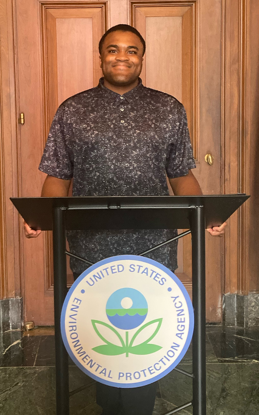 Xavier Smalls standing behind a lectern with the Environmental Protection Agency seal on it.